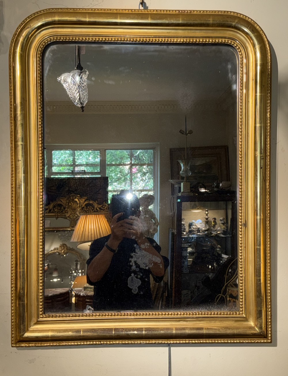 A rectangular French Louis Philippe giltwood wall mirror featuring rounded upper corners and a beaded inner moulding. View IV