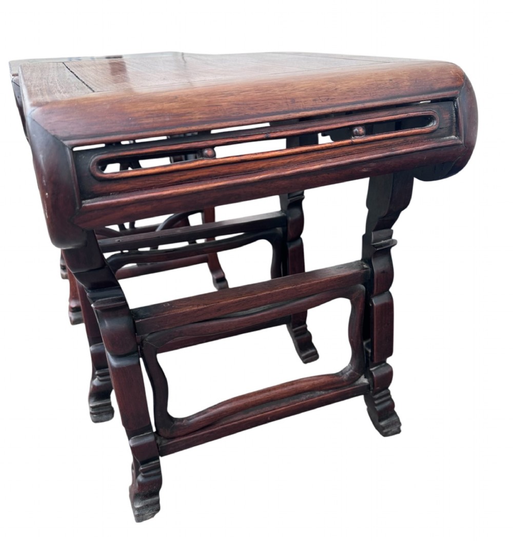A pair of 19th-century carved dark hardwood side tables with scrolled tops and pierced floral aprons. View III