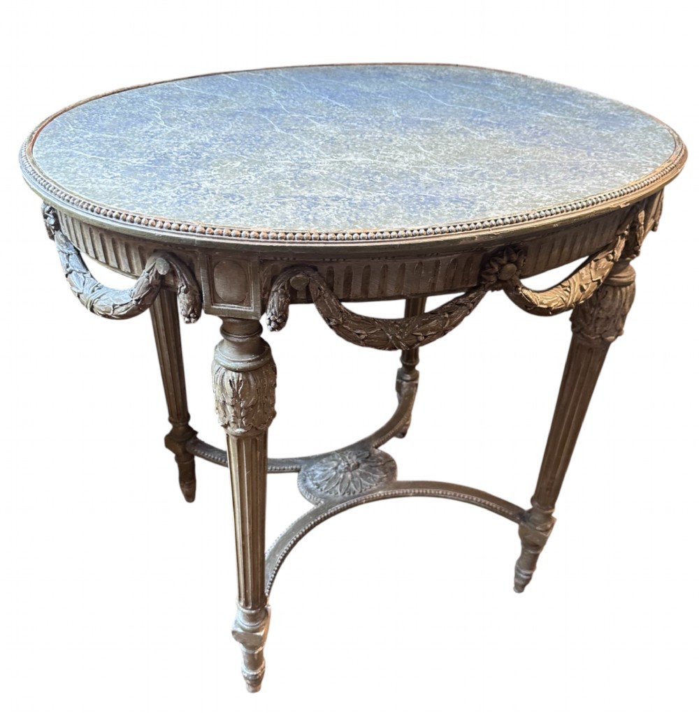 A 19th-century French Louis XVI style oval occasional table featuring a blue-green marble top, carved draped swags, fluted legs, and a central rosette stretcher. View III