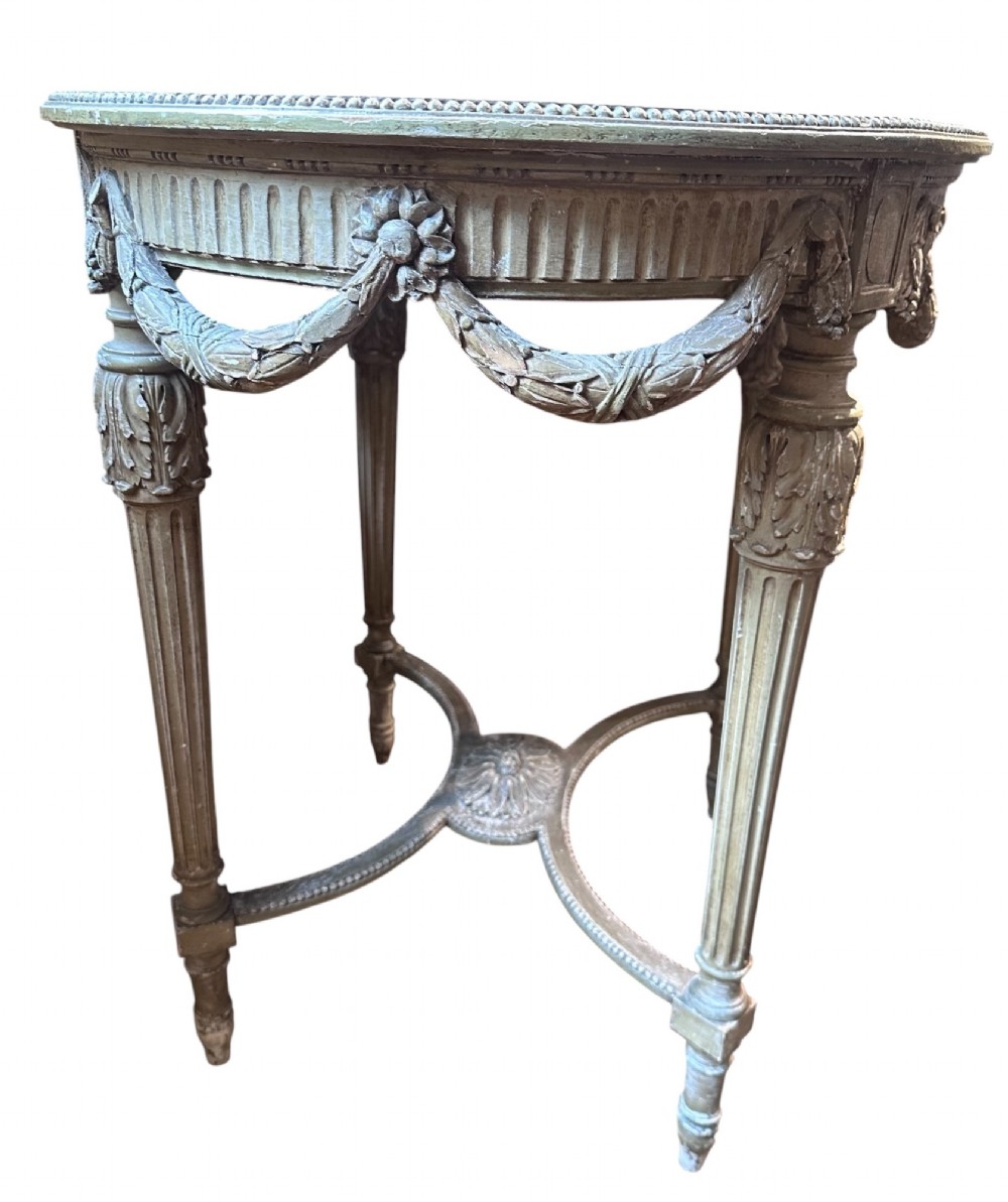 A 19th-century French Louis XVI style oval occasional table featuring a blue-green marble top, carved draped swags, fluted legs, and a central rosette stretcher. View IV