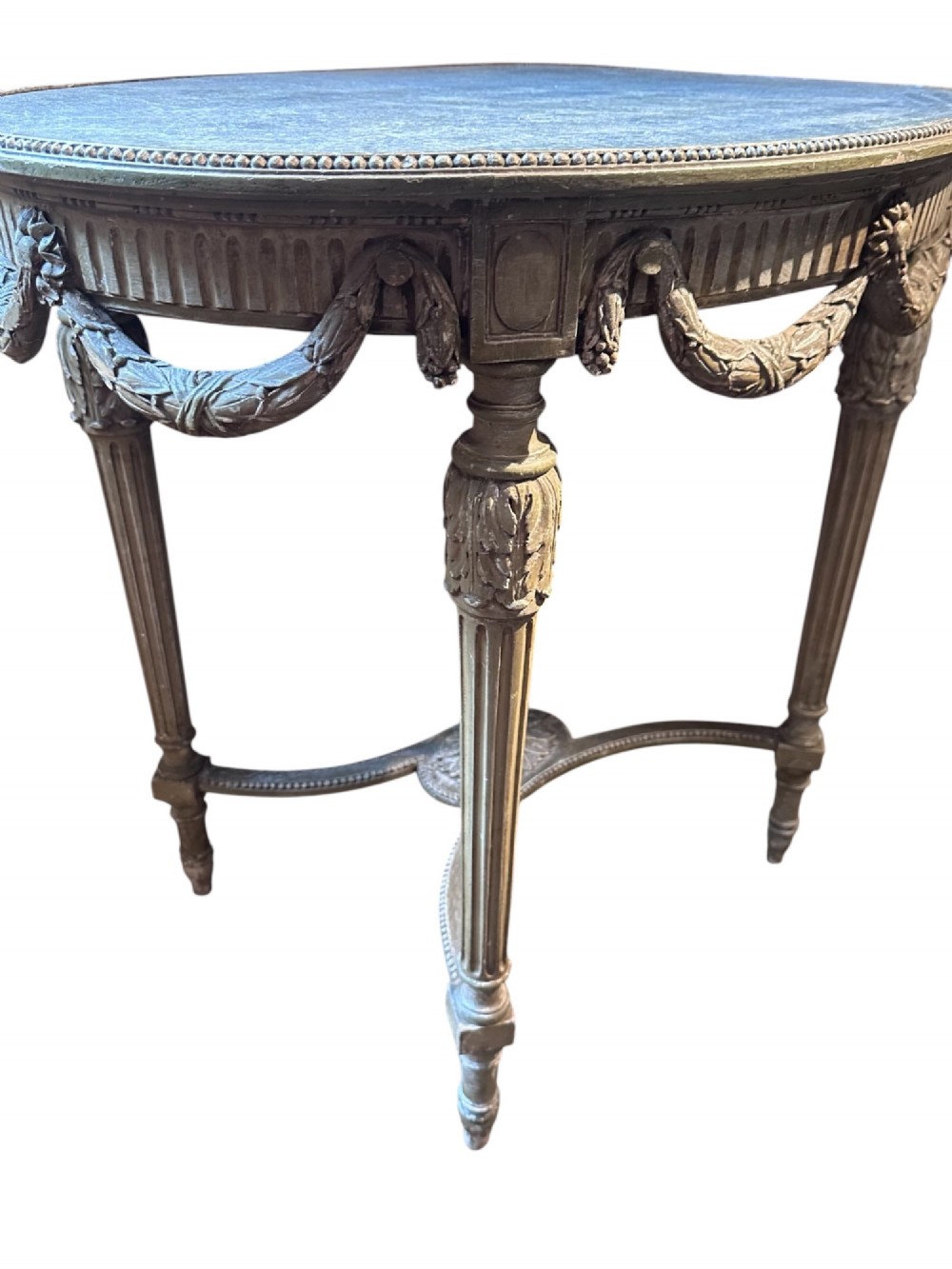 A 19th-century French Louis XVI style oval occasional table featuring a blue-green marble top, carved draped swags, fluted legs, and a central rosette stretcher. View V