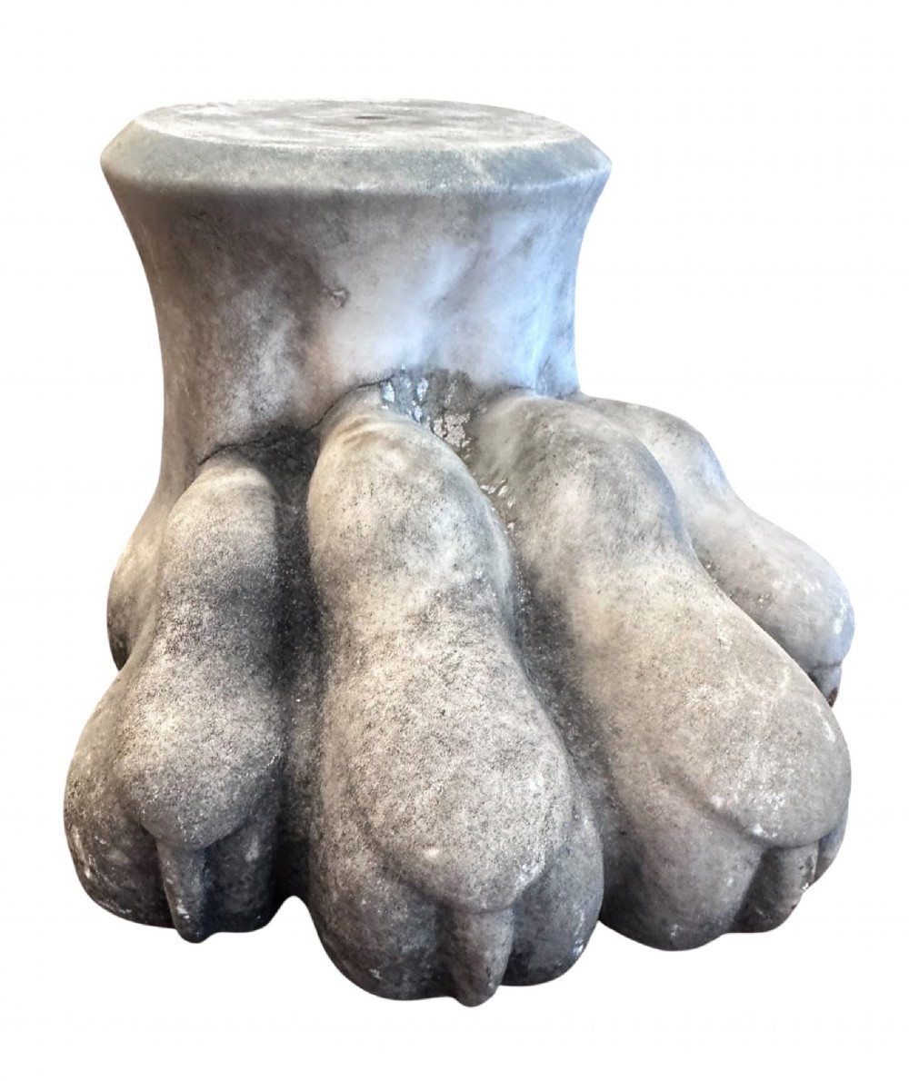A carved light grey Carrara marble lions paw foot with detailed claws and a rounded collar base.