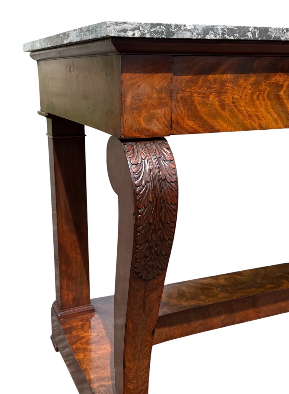 A 19th-century French Louis Philippe mahogany console table featuring a grey marble top, single frieze drawer, curved scroll front legs with acanthus carvings, and an incurved plinth base. View III