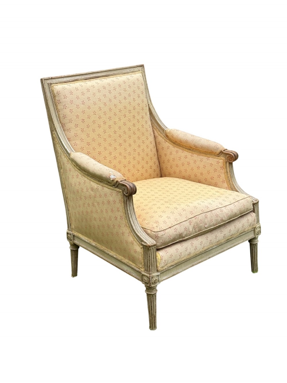 An 18th-century French Louis XVI armchair featuring a distressed grey painted wooden frame with fluted tapered legs and cream patterned upholstery.