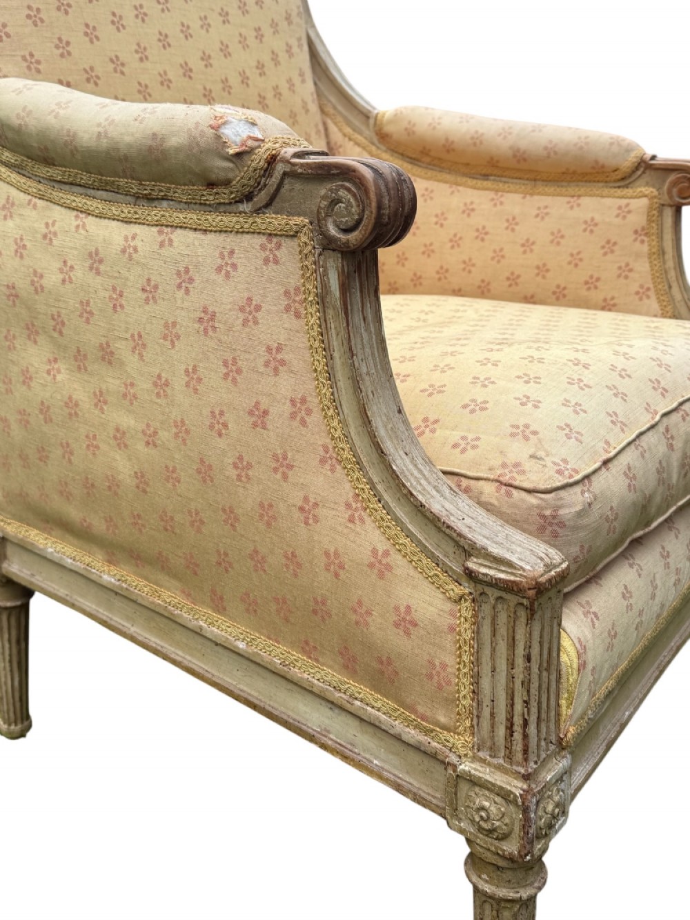 An 18th-century French Louis XVI armchair featuring a distressed grey painted wooden frame with fluted tapered legs and cream patterned upholstery. View V
