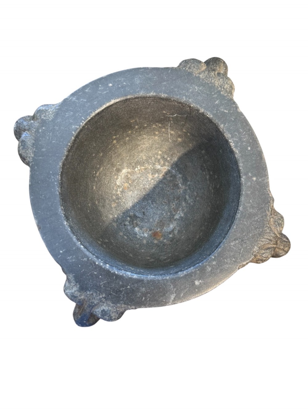 An 18th century dark charcoal basalt stone mortar featuring carved lion head handles and a rounded pedestal foot. View IV