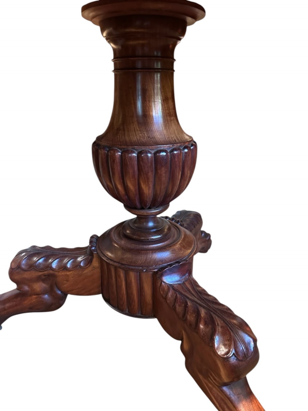 A 19th-century French Louis Philippe gueridon table featuring a dark polished marble top resting on a mahogany apron, turned pedestal column, and carved tripod feet. View II
