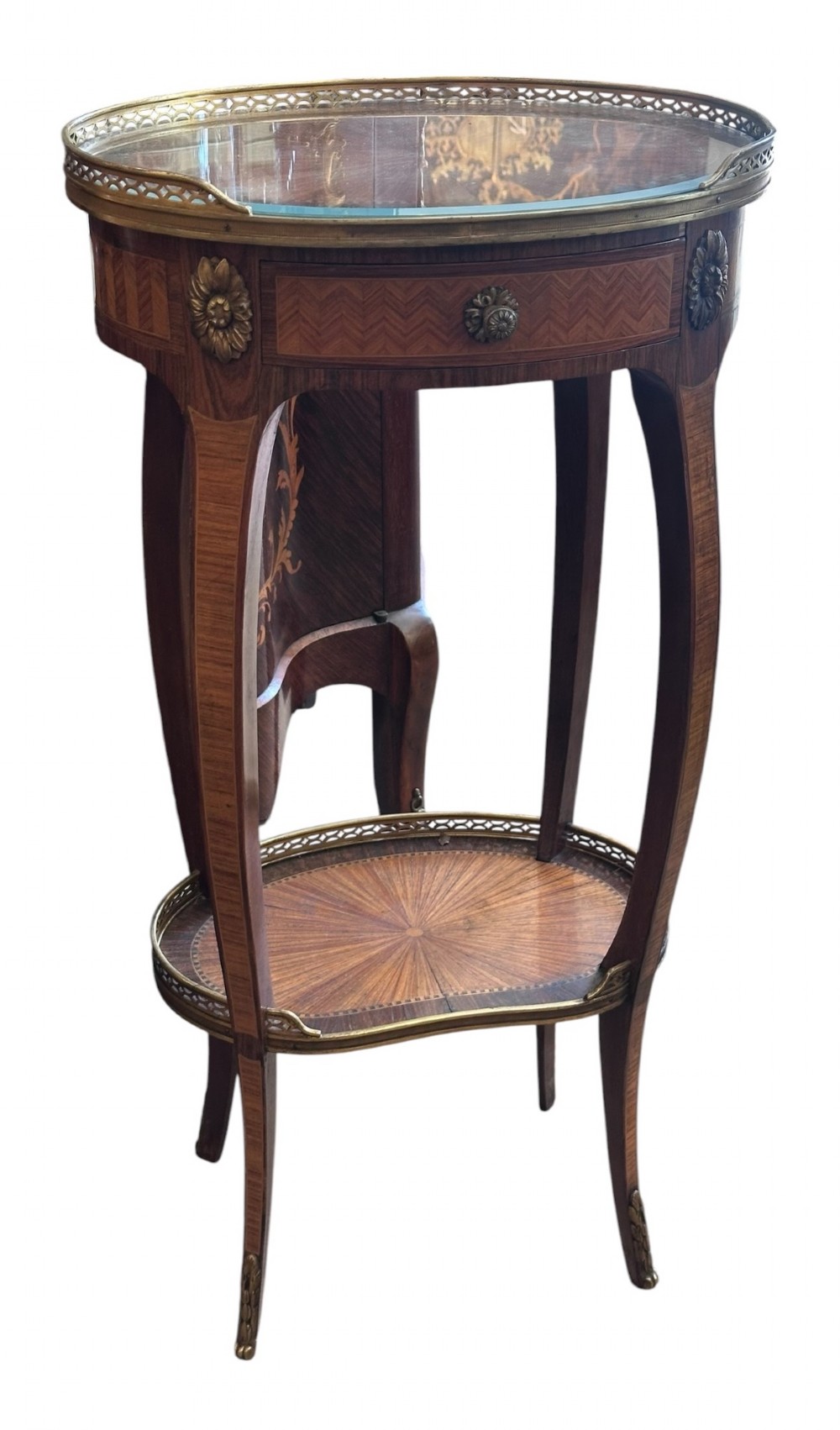 A pair of oval kingwood bedside tables featuring brass gallery rails, glass tops, lower undertier shelves, and slender cabriole legs with metal mounts. View II