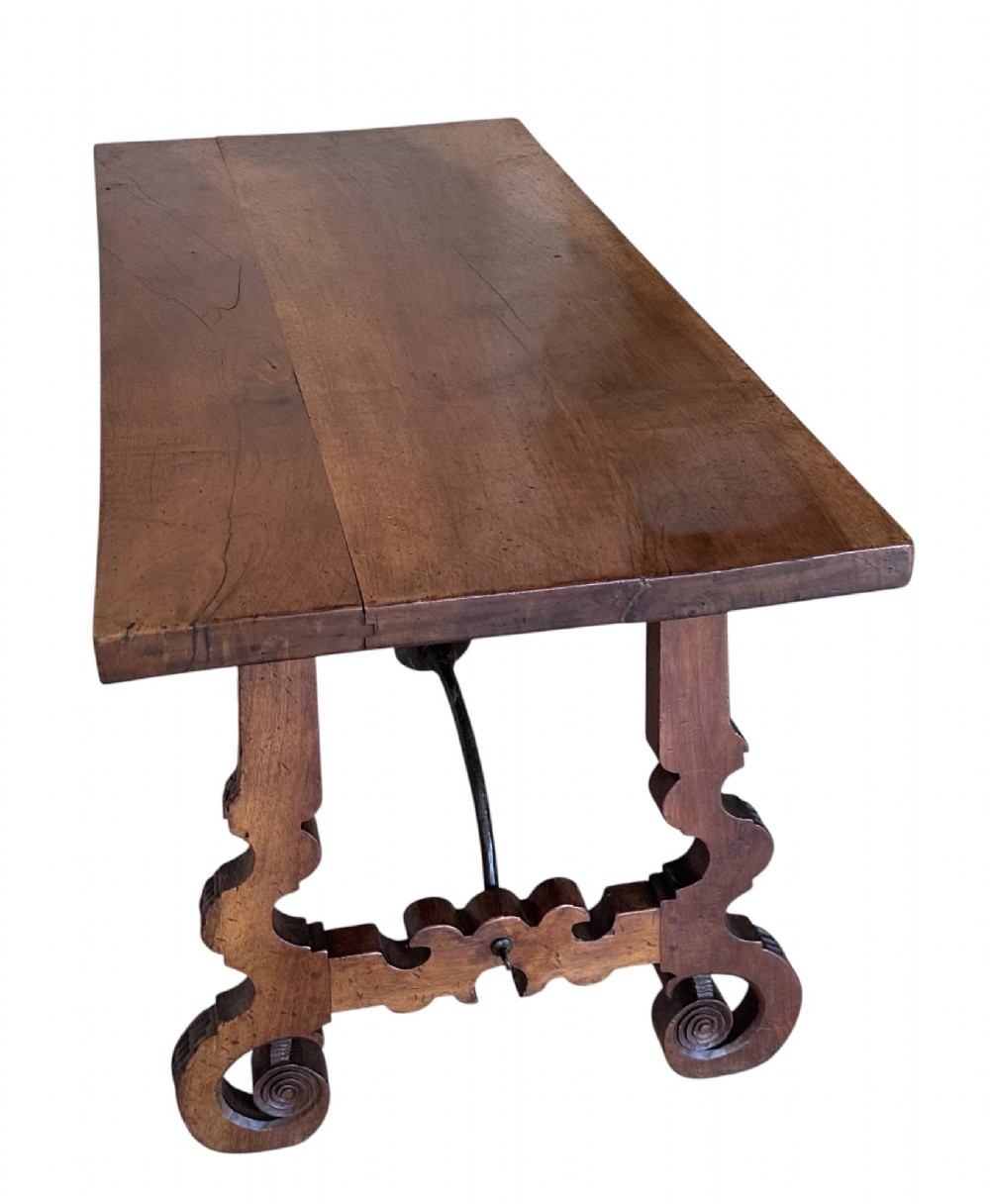 A nineteenth-century Spanish walnut dining table featuring carved lyre-shaped trestle legs and curved wrought iron stretchers. View III