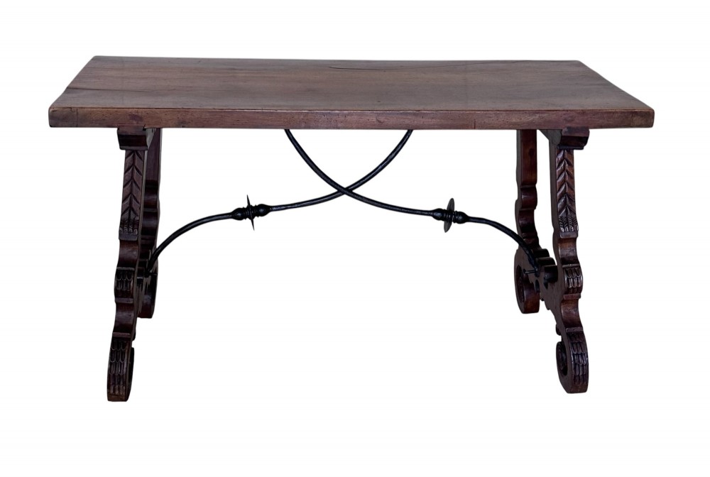 A nineteenth-century Spanish walnut dining table featuring carved lyre-shaped trestle legs and curved wrought iron stretchers. View IV