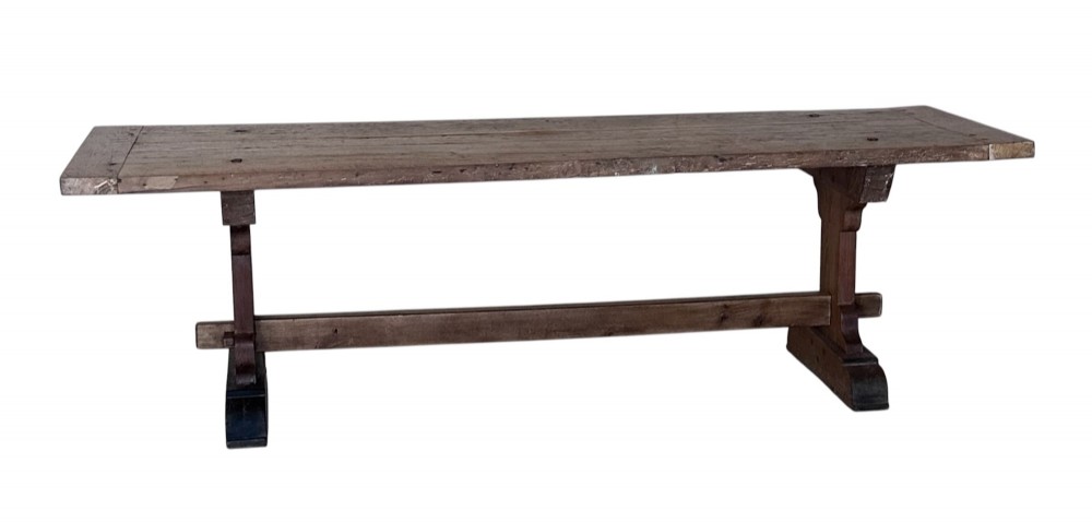 An 18th-century French refectory dining table constructed from beech timber with a solid plank top and a trestle base connected by a low stretcher. View II