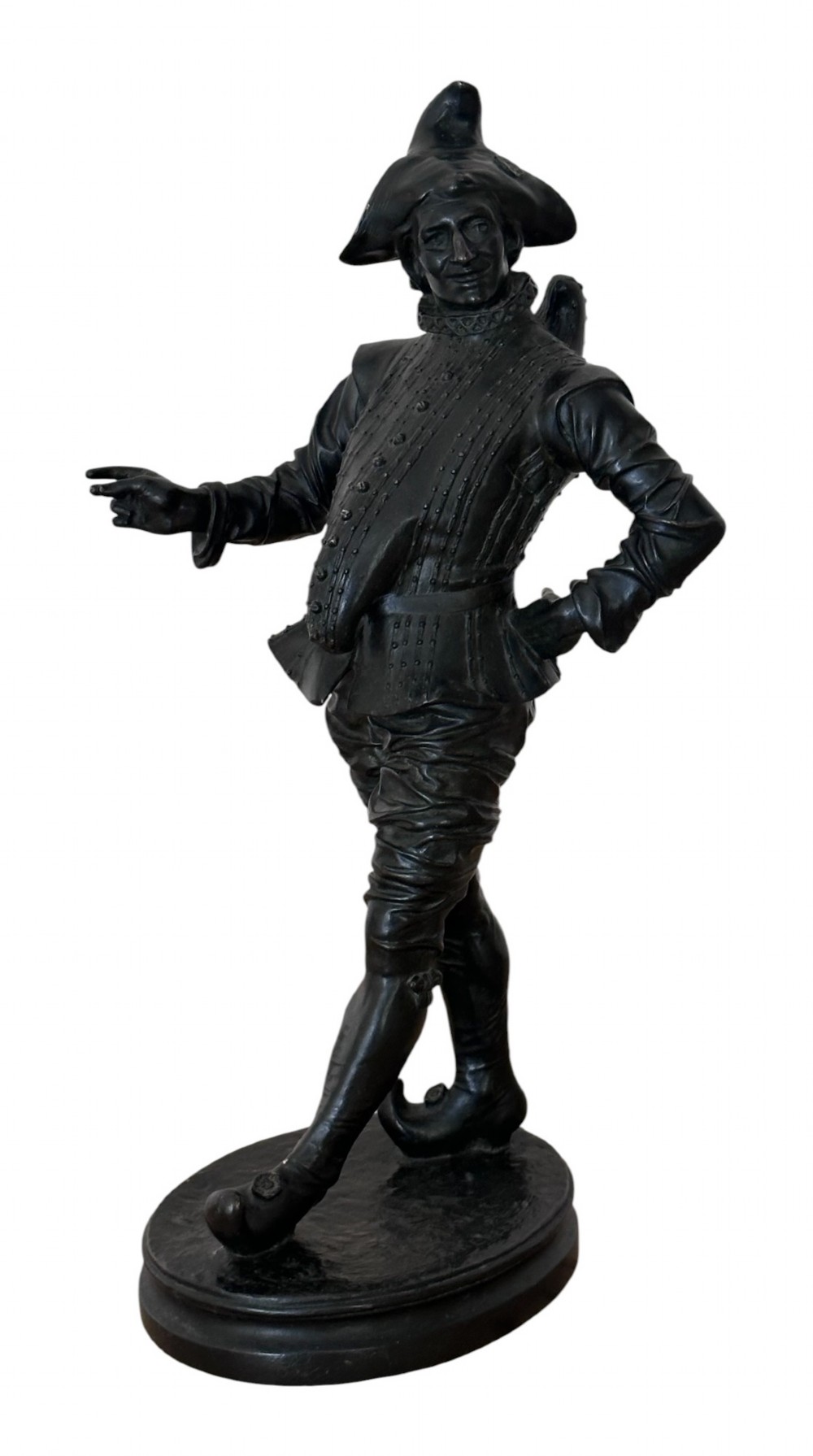 A nineteenth-century dark patinated bronze figure depicting the Commedia dellarte character Pulcinella standing on an oval base with one arm gestured outward.