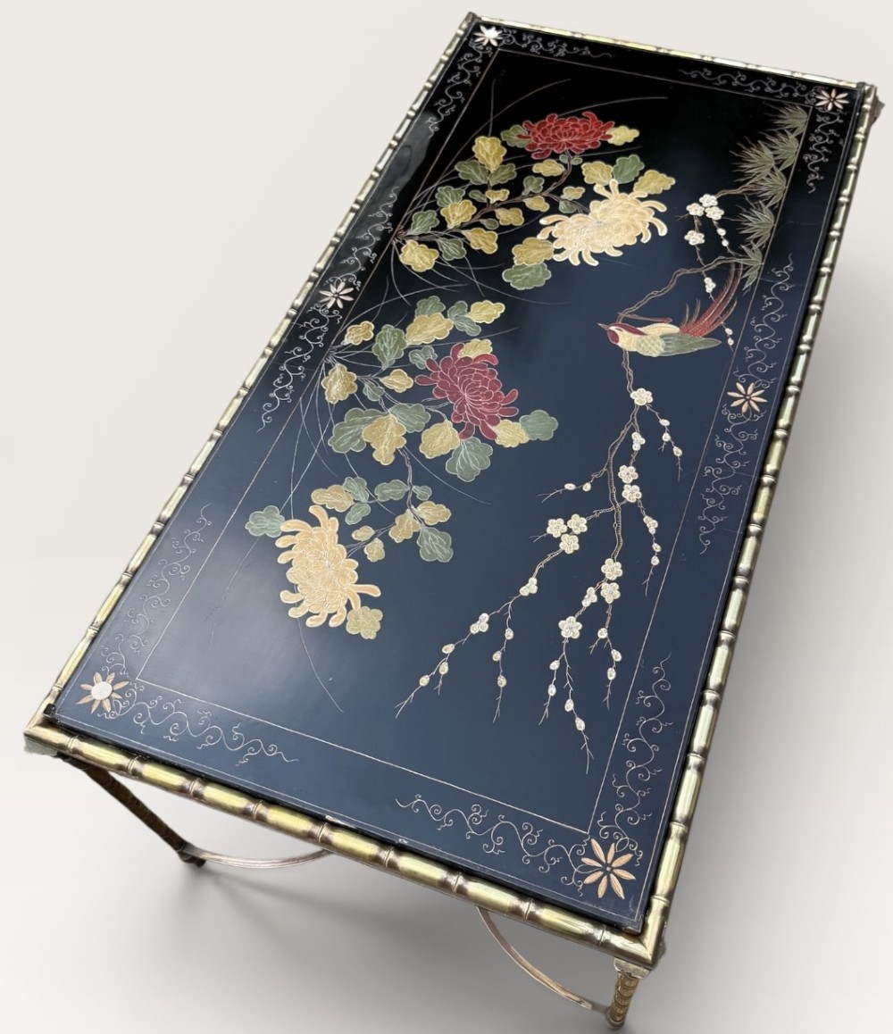 A rectangular mid-century low table featuring a faux-bamboo brass frame, X-form stretchers, and a black lacquered top decorated with colourful Chinoiserie floral patterns. View VIII