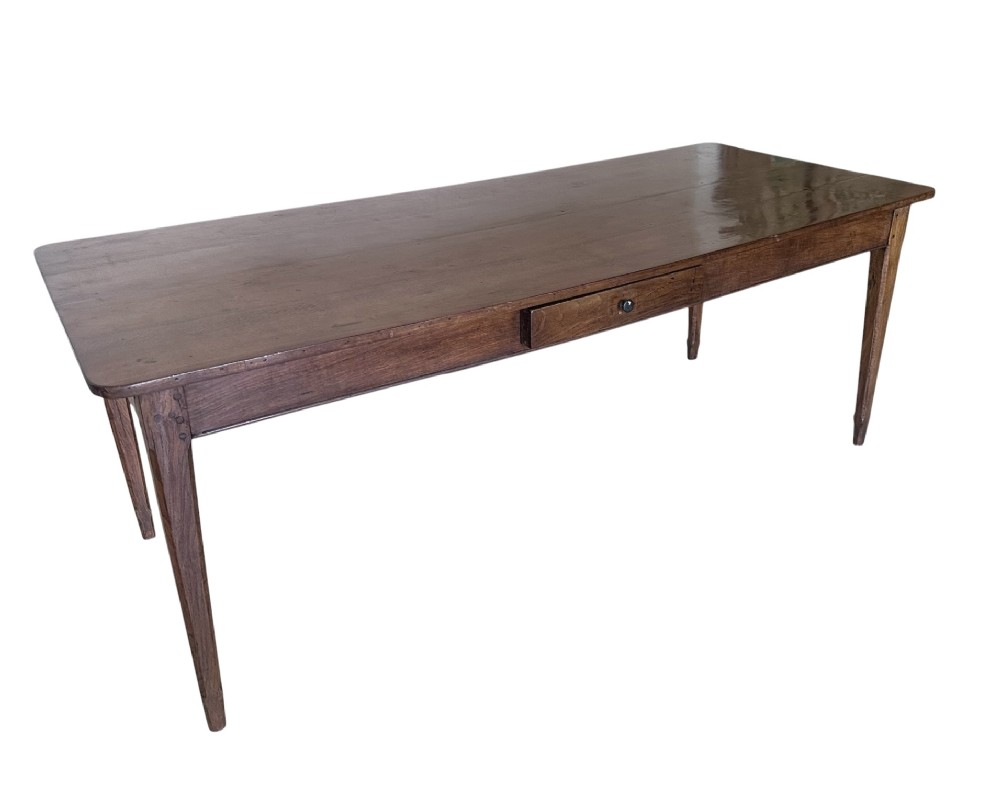 A large nineteenth-century French oak farmhouse table featuring a rectangular plank top, a frieze drawer with a wooden knob, and four tapered square legs. View II