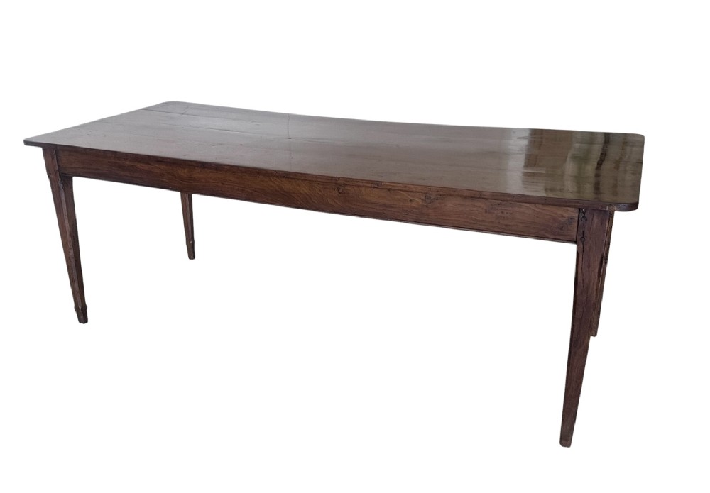 A large nineteenth-century French oak farmhouse table featuring a rectangular plank top, a frieze drawer with a wooden knob, and four tapered square legs. View VI
