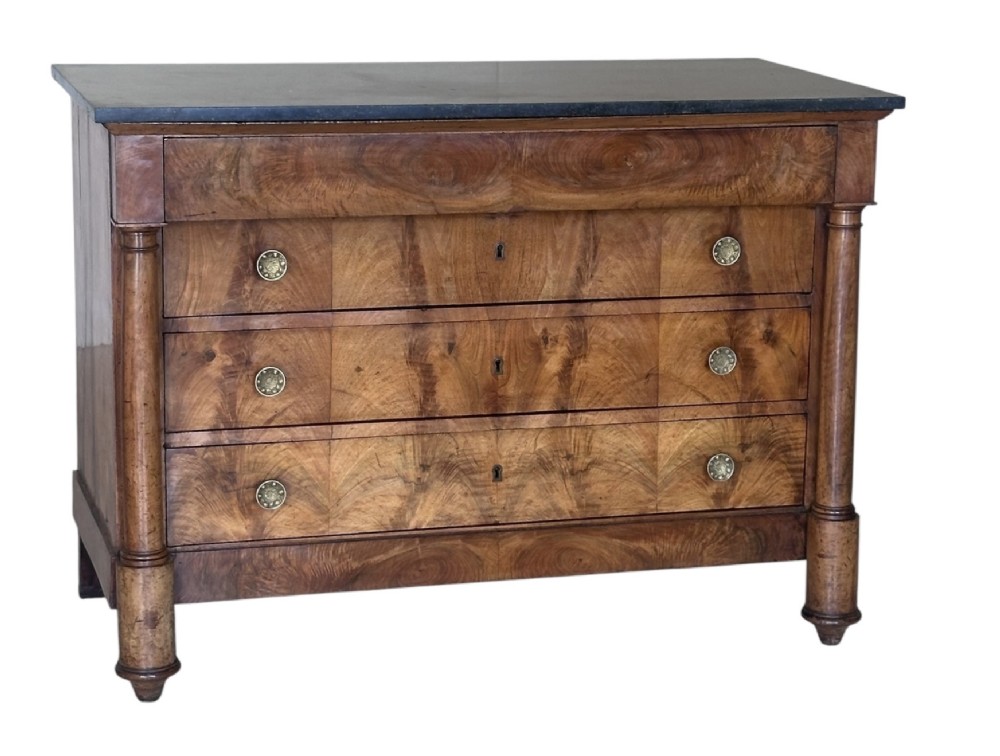 A 19th-century French Charles X walnut commode featuring three lower drawers with round metal pulls, flanked by architectural side columns and topped with a dark marble slab. View II