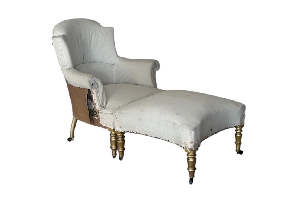 A two-piece late nineteenth-century French duchesse brisee chaise longue in calico upholstery featuring turned gilded legs on castors.