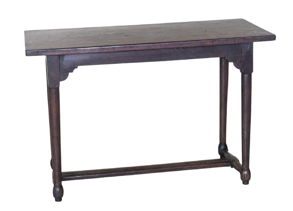 An 18th-century dark oak rectangular side table featuring turned legs connected by a low stretcher rail. View II
