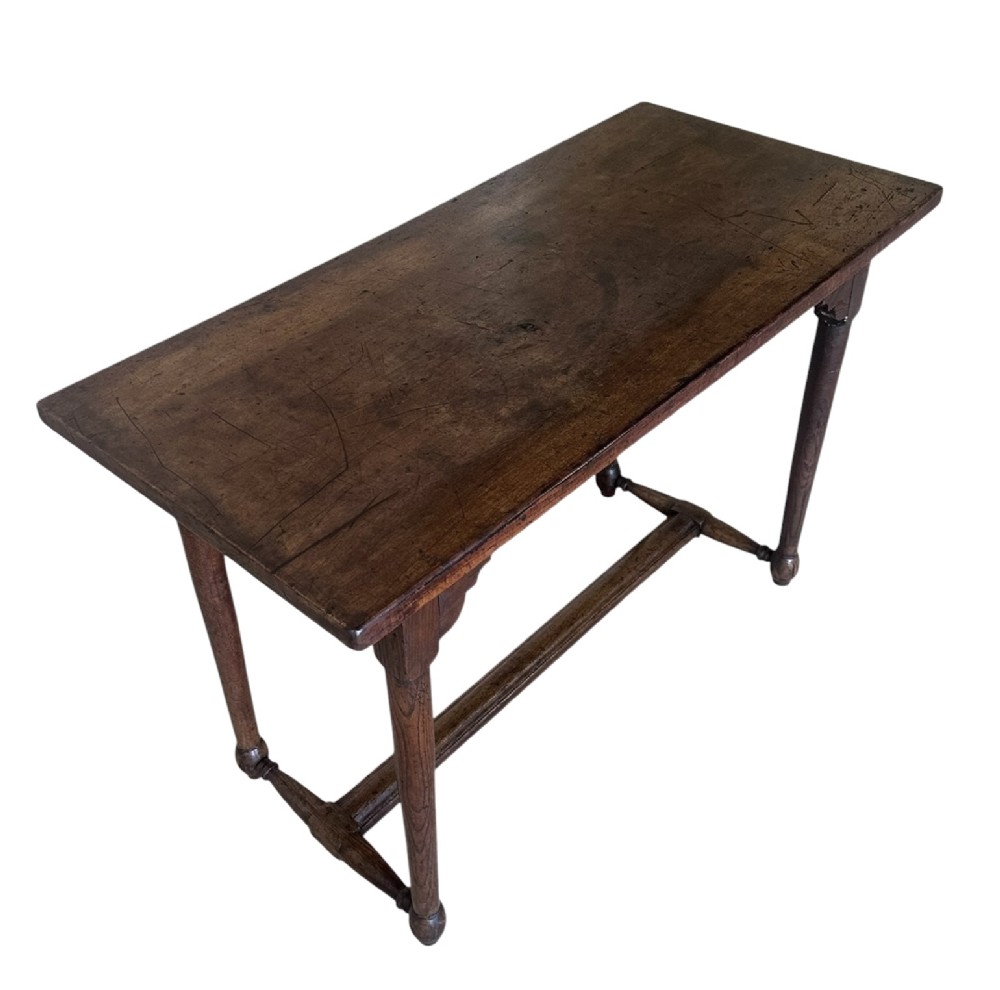 An 18th-century dark oak rectangular side table featuring turned legs connected by a low stretcher rail. View III