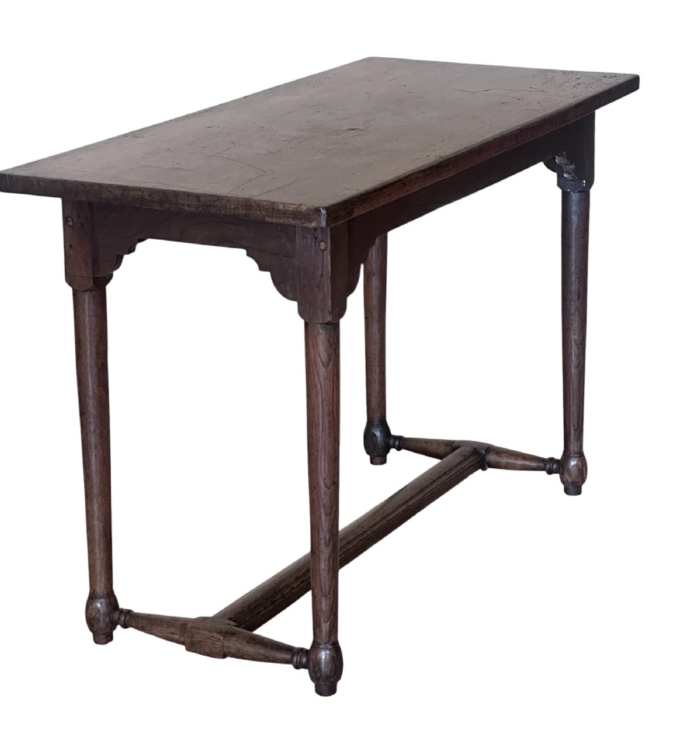 An 18th-century dark oak rectangular side table featuring turned legs connected by a low stretcher rail. View IV