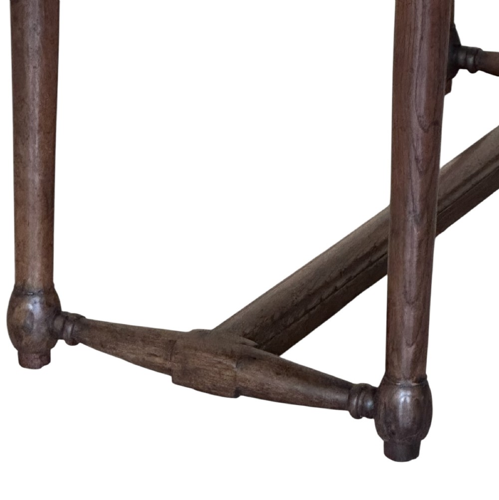 An 18th-century dark oak rectangular side table featuring turned legs connected by a low stretcher rail. View V