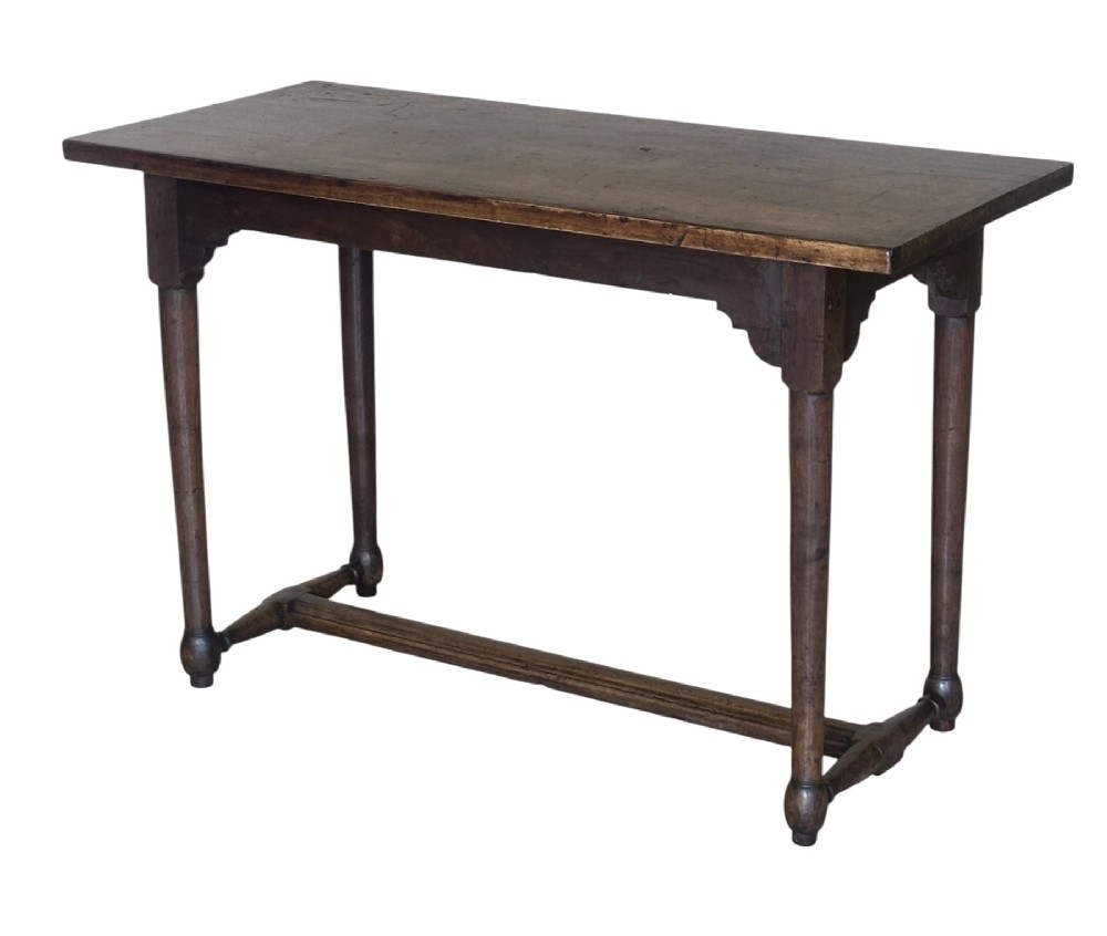 An 18th-century dark oak rectangular side table featuring turned legs connected by a low stretcher rail. View VI