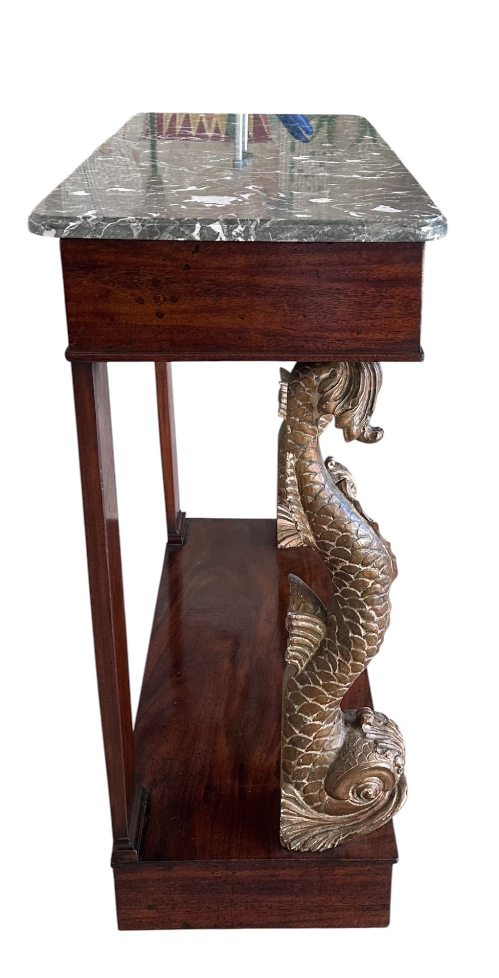 A 19th-century mahogany console table featuring a grey marble top, gilded carved dolphin front supports, and a low plinth base. View III