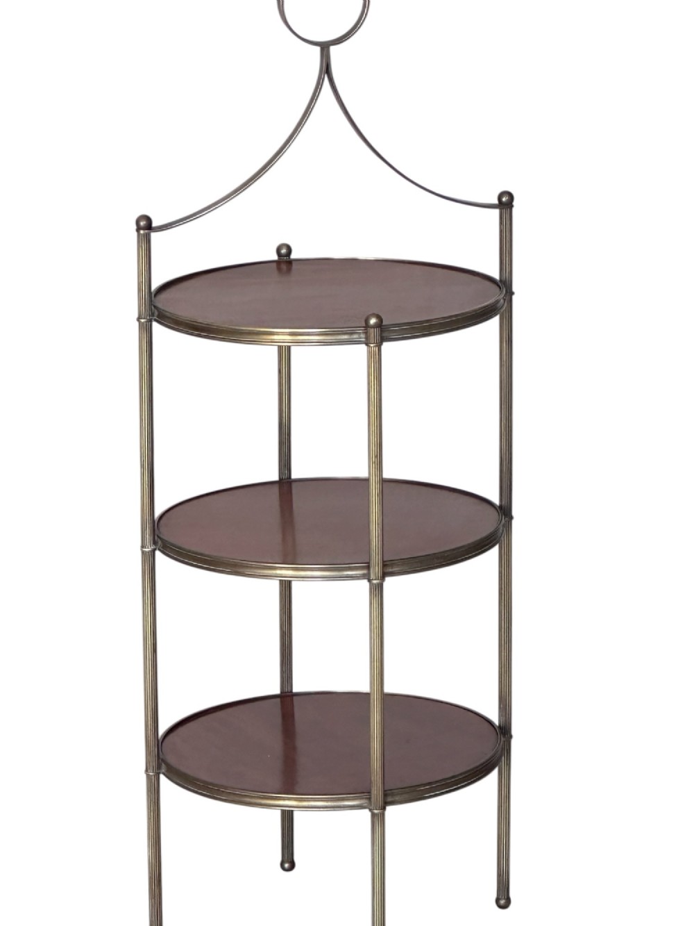 An early 20th-century three-tiered mahogany and brass etagere featuring reeded metal supports and a top carrying ring.