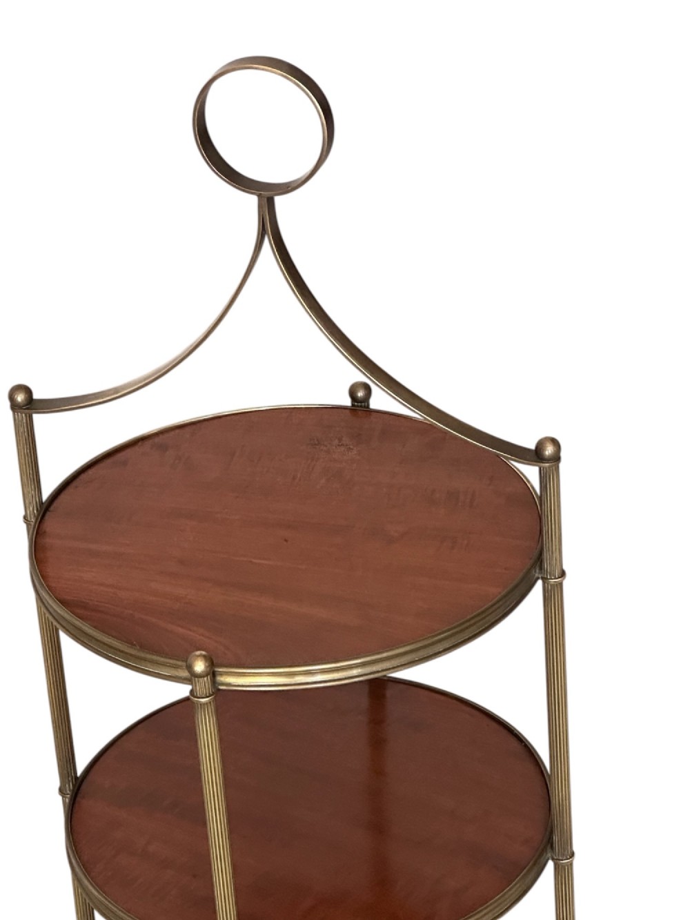 An early 20th-century three-tiered mahogany and brass etagere featuring reeded metal supports and a top carrying ring. View III