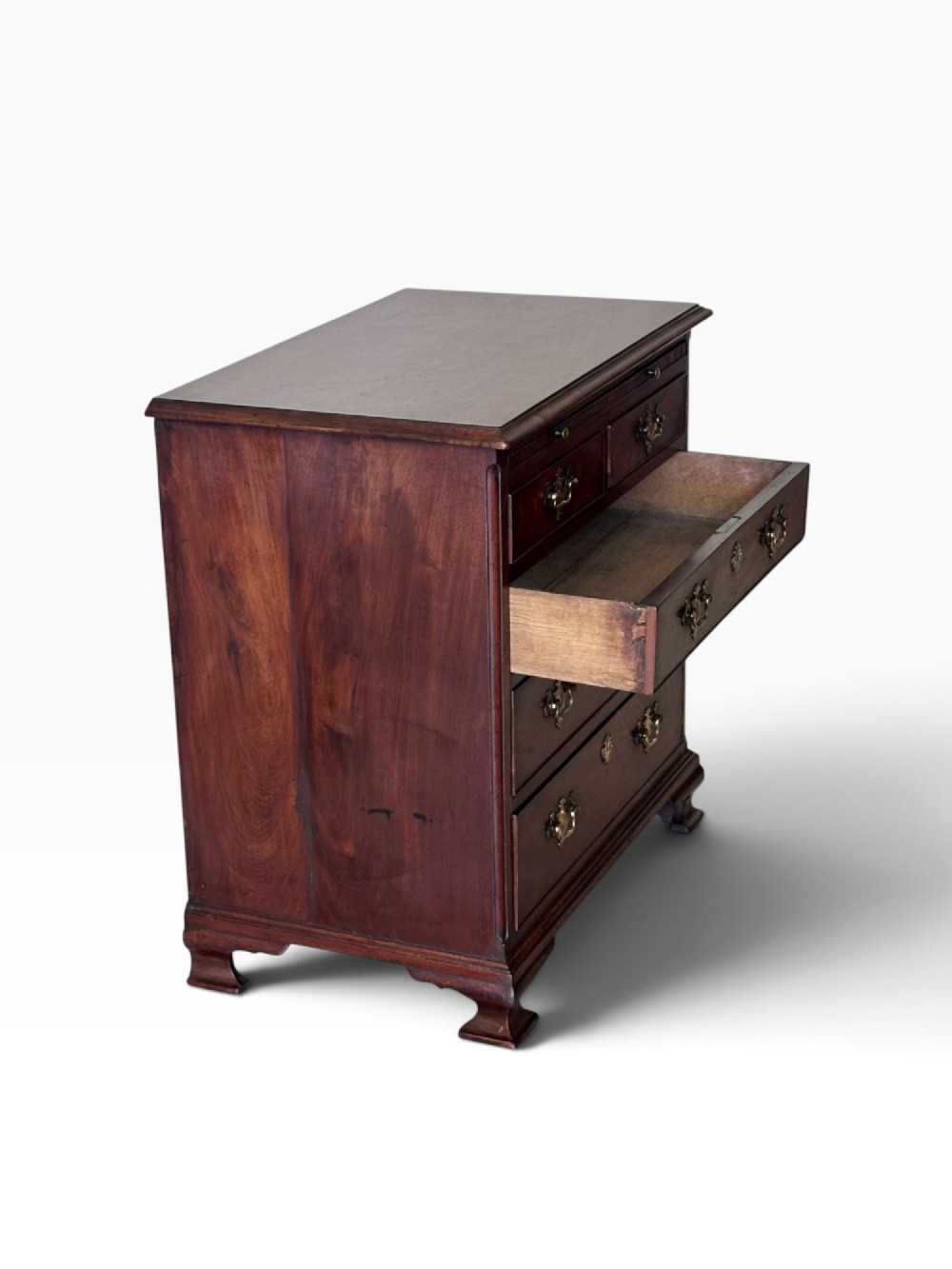 An 18th-century Georgian mahogany chest of drawers featuring a pull-out brushing slide, two short over three long drawers, brass handles, and bracket feet. View IV