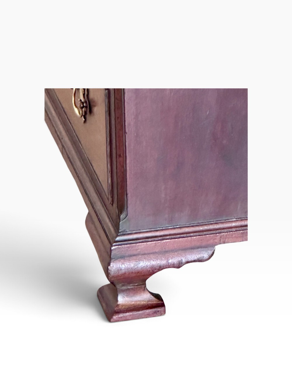 An 18th-century Georgian mahogany chest of drawers featuring a pull-out brushing slide, two short over three long drawers, brass handles, and bracket feet. View VI