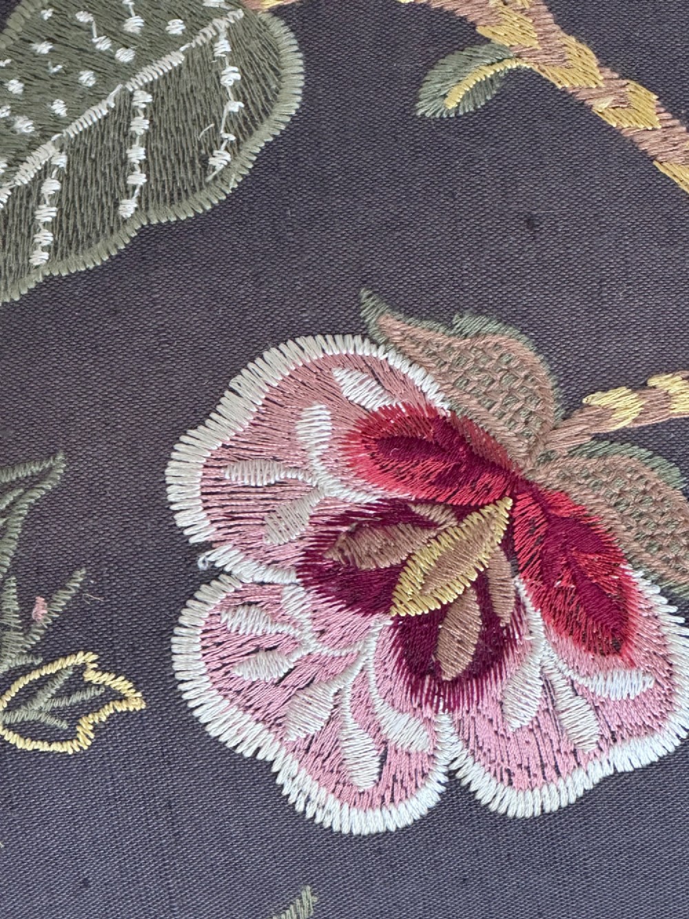 A 19th-century William and Mary style walnut stool featuring turned legs, a curved X-frame stretcher, and dark upholstered top embroidered with colourful floral motifs. View VIII