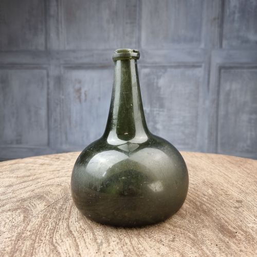An 18th Century Green Onion Bottle.