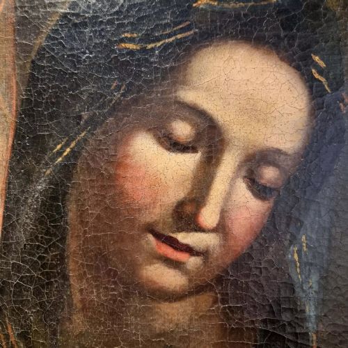 An oil painting depicting the Madonna and Child housed in a carved gold giltwood frame with a top crest. View IX