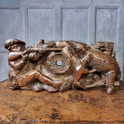 A late 17th-century carved oak relief panel depicting a hunter taking aim with a musket at a wild boar and hunting dog. View III