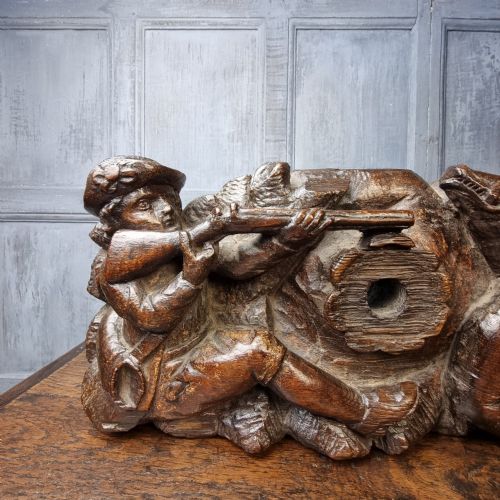 A late 17th-century carved oak relief panel depicting a hunter taking aim with a musket at a wild boar and hunting dog. View IV