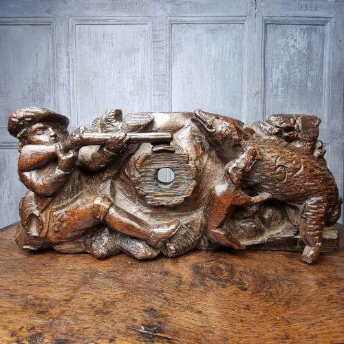 A late 17th-century carved oak relief panel depicting a hunter taking aim with a musket at a wild boar and hunting dog. View V