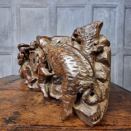 A late 17th-century carved oak relief panel depicting a hunter taking aim with a musket at a wild boar and hunting dog. View VII