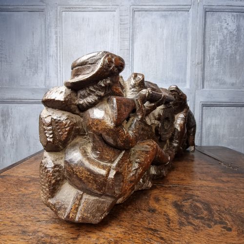 A late 17th-century carved oak relief panel depicting a hunter taking aim with a musket at a wild boar and hunting dog. View VIII