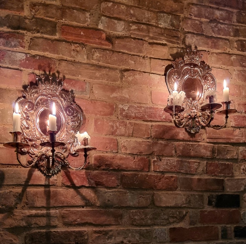 A pair of 19th century repousse wall sconces. 