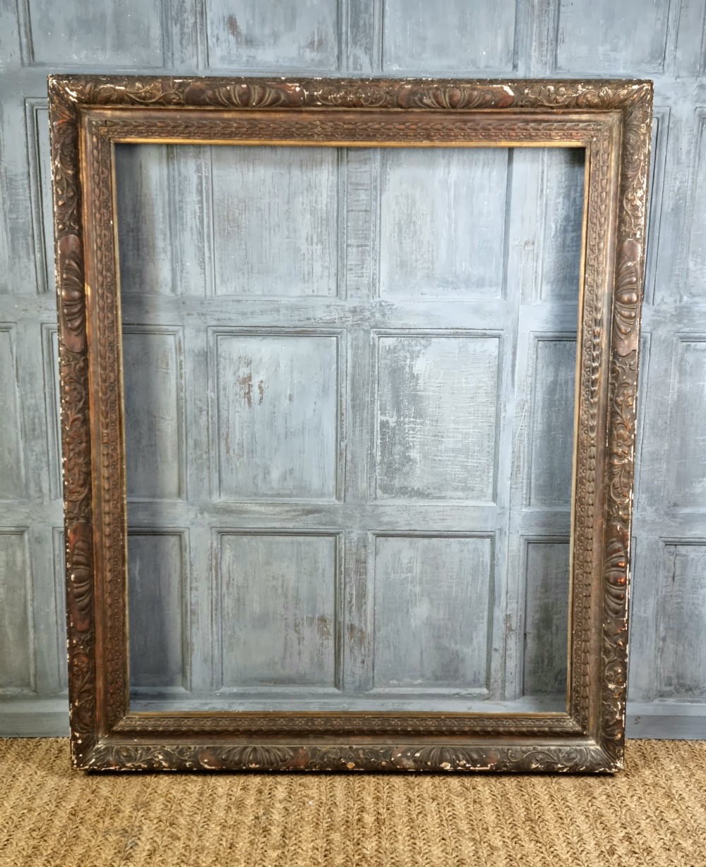 A large 17thC style carved picture frame.