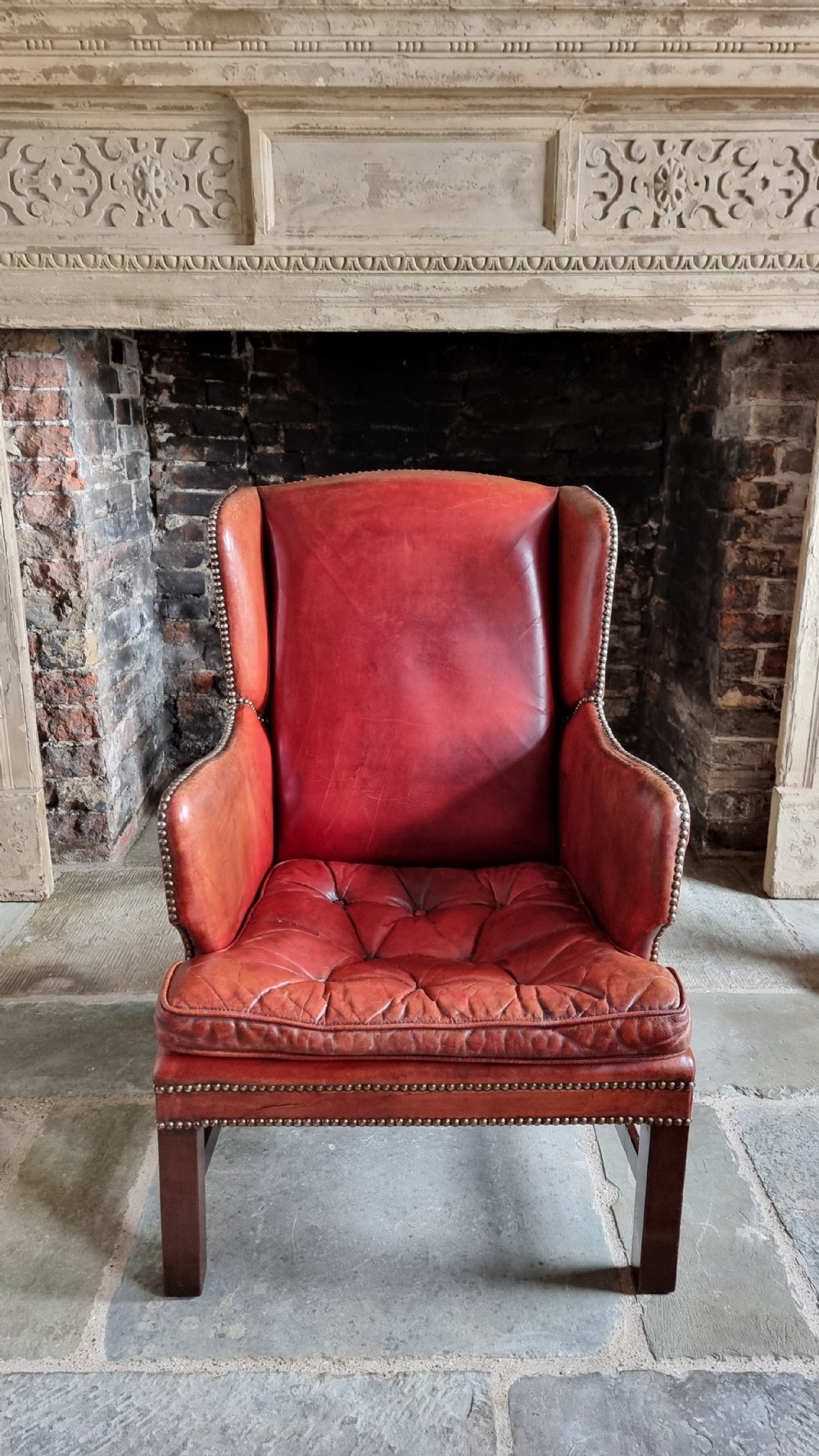 A small Georgian style leather wingchair.  View II
