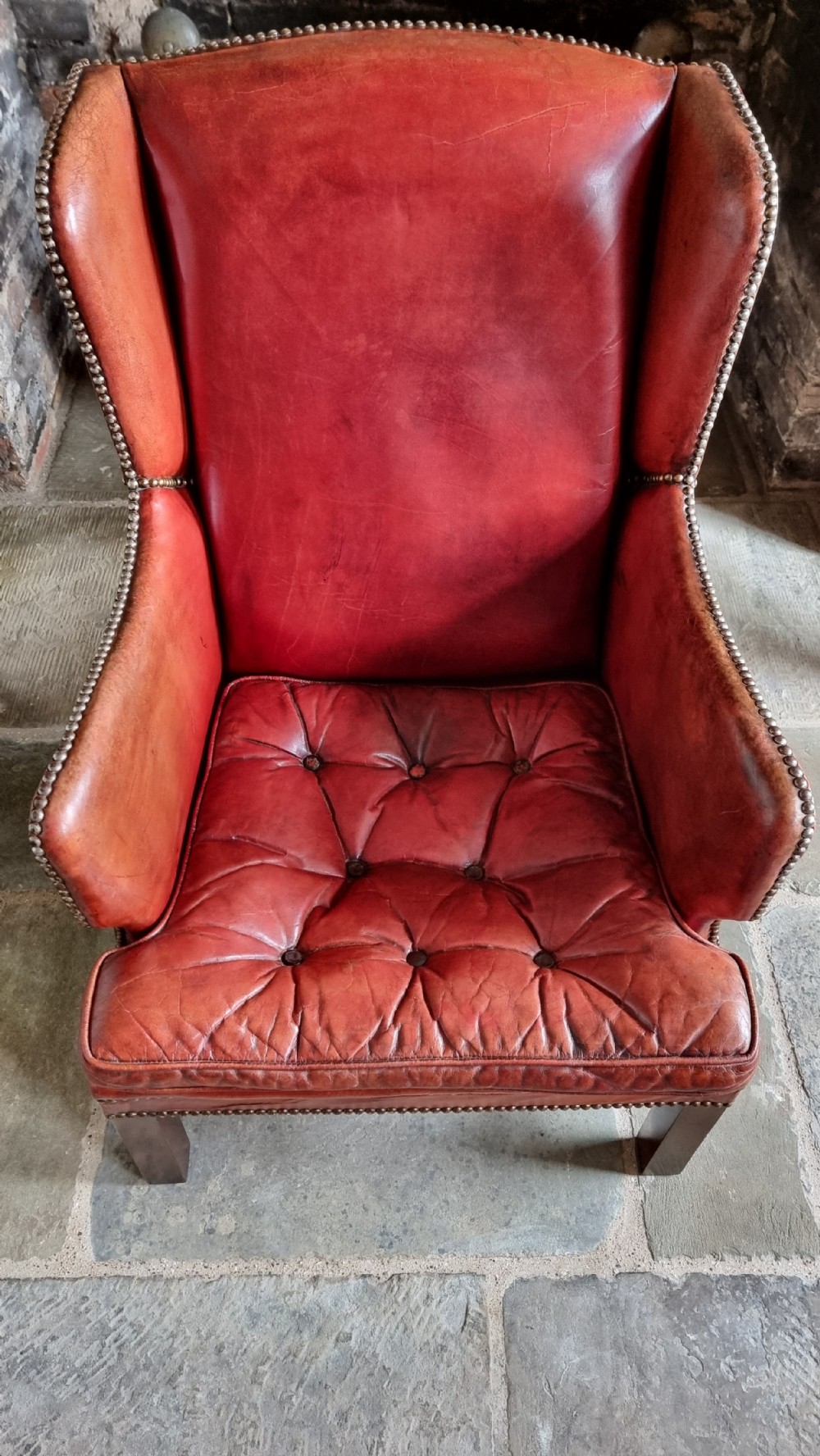 A small Georgian style leather wingchair.  View III
