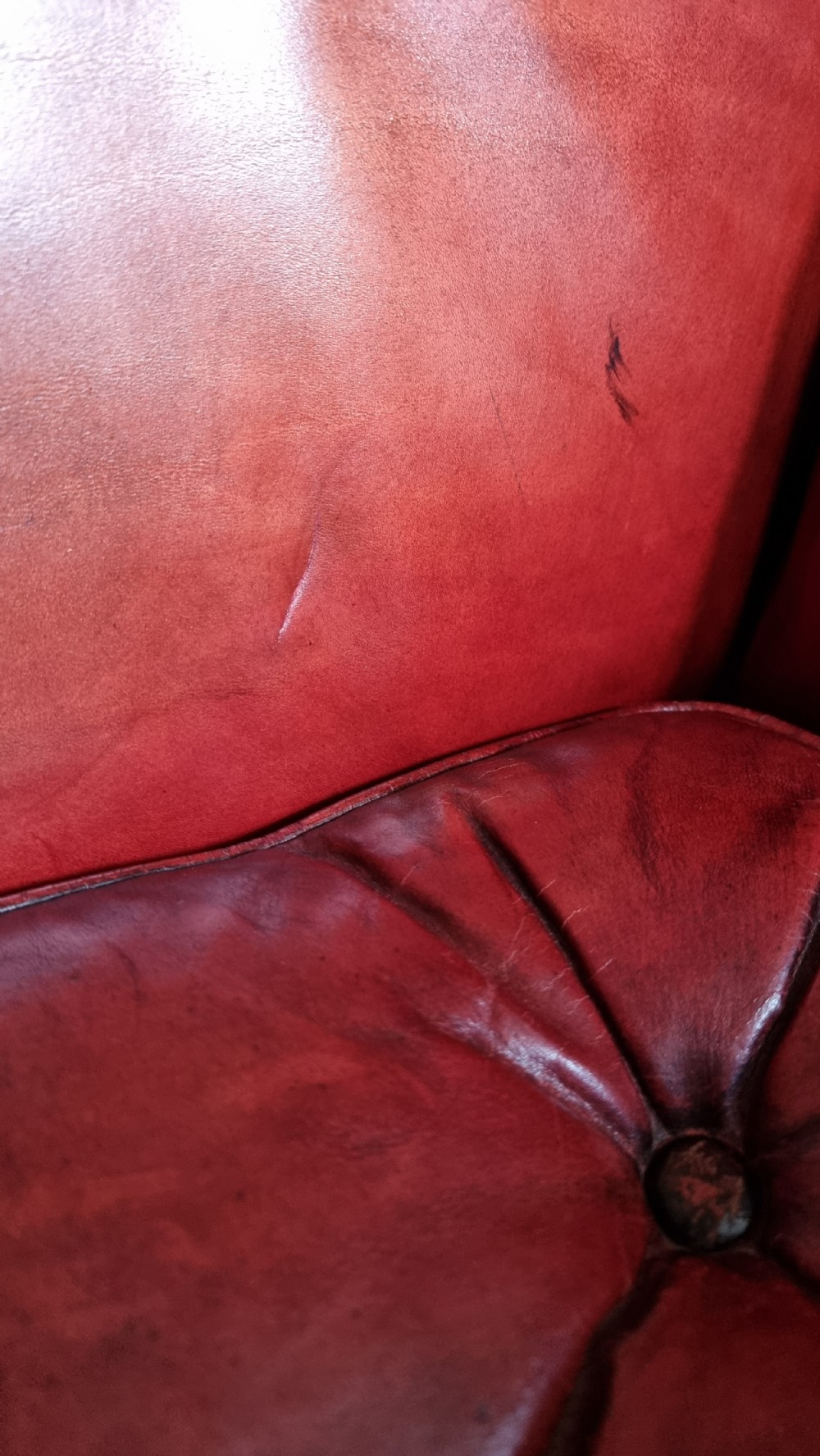 A small Georgian style leather wingchair.  View IV