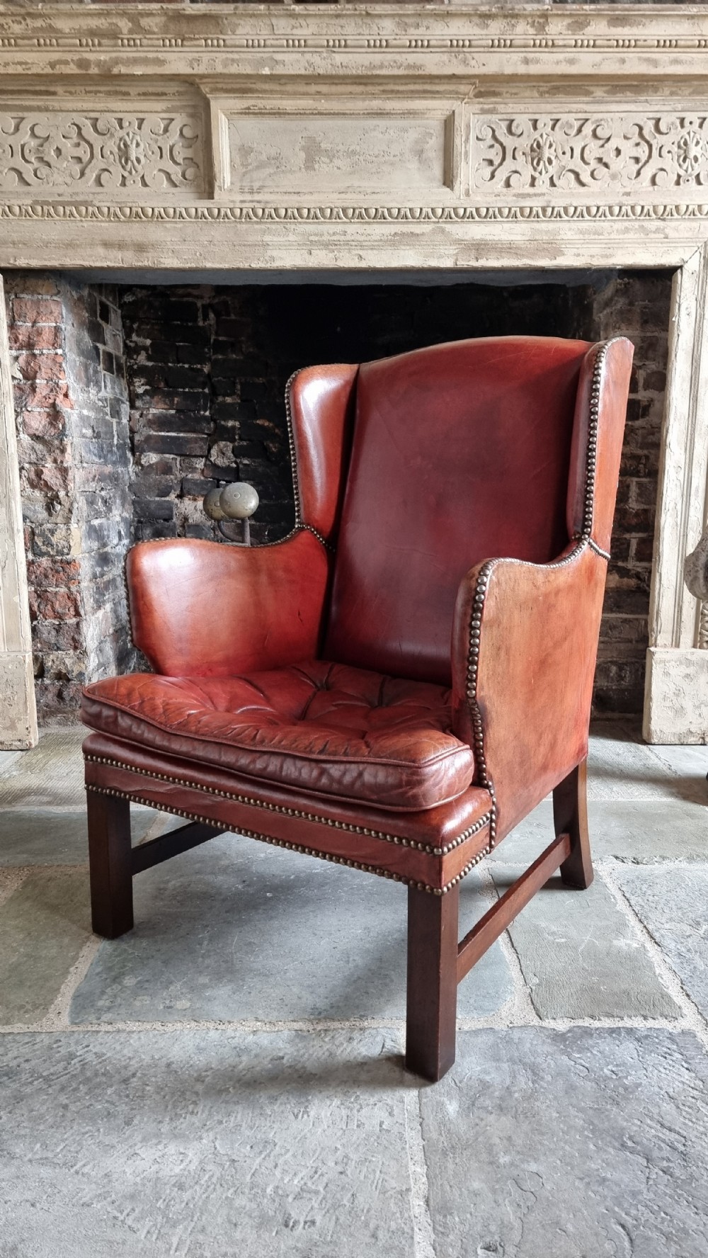 A small Georgian style leather wingchair.  View VI