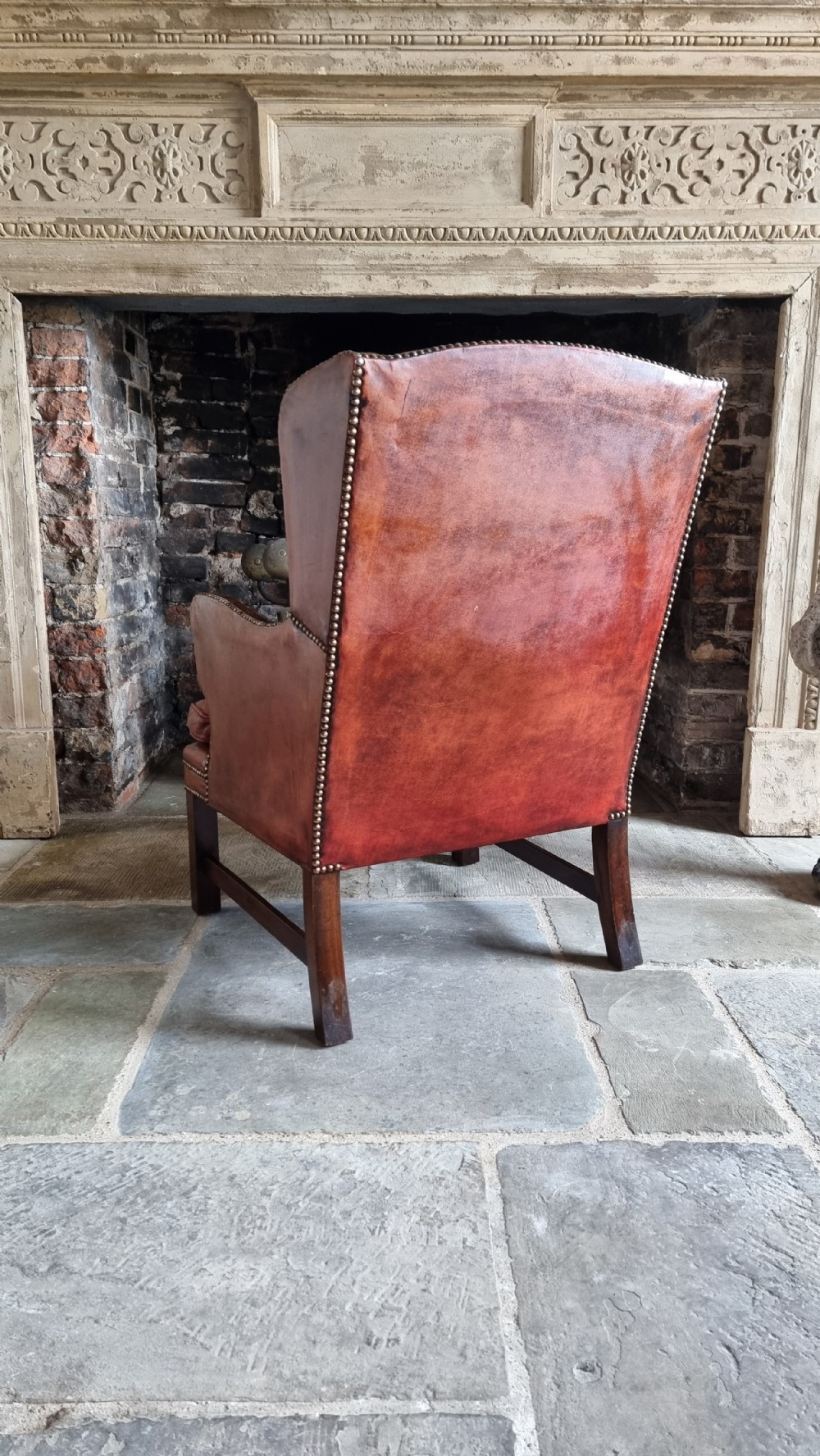 A small Georgian style leather wingchair.  View X