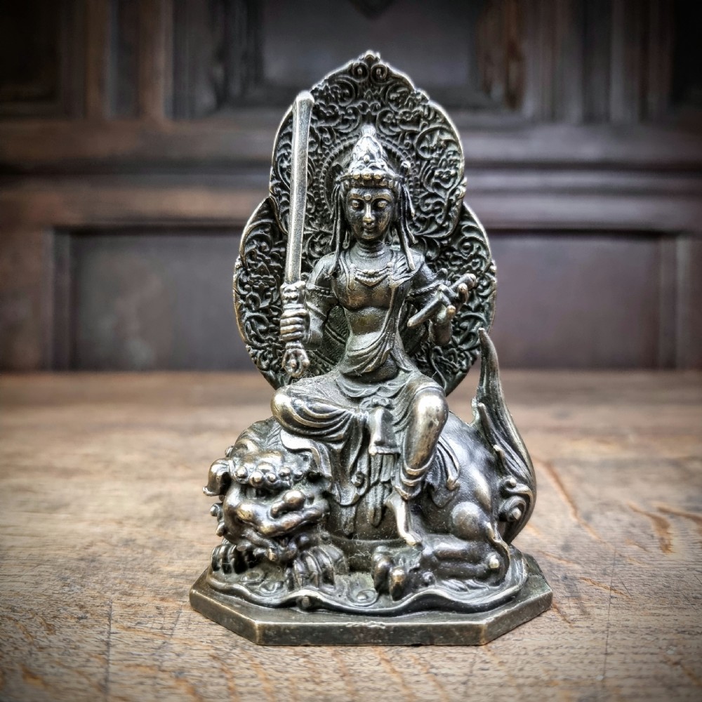 A small 19th century bronze figure of Guanyin.