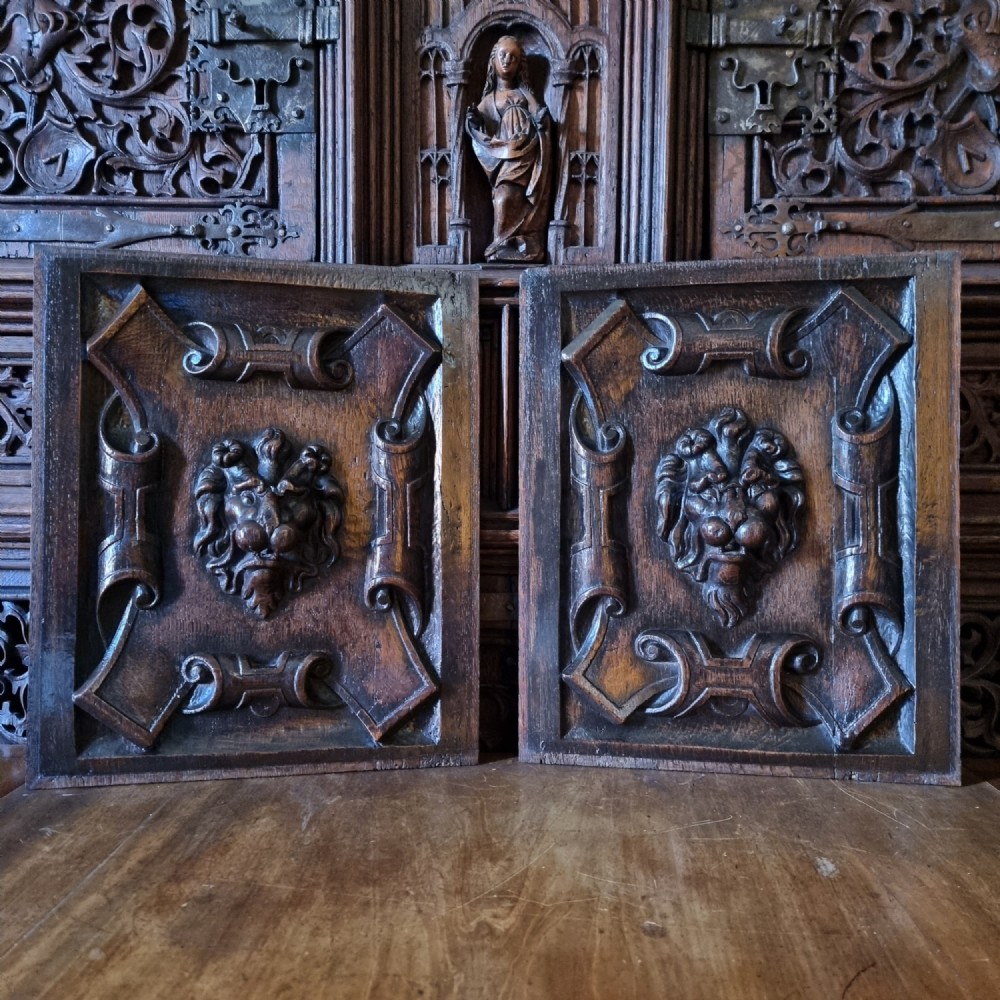 A pair of 17th century lions mask panels