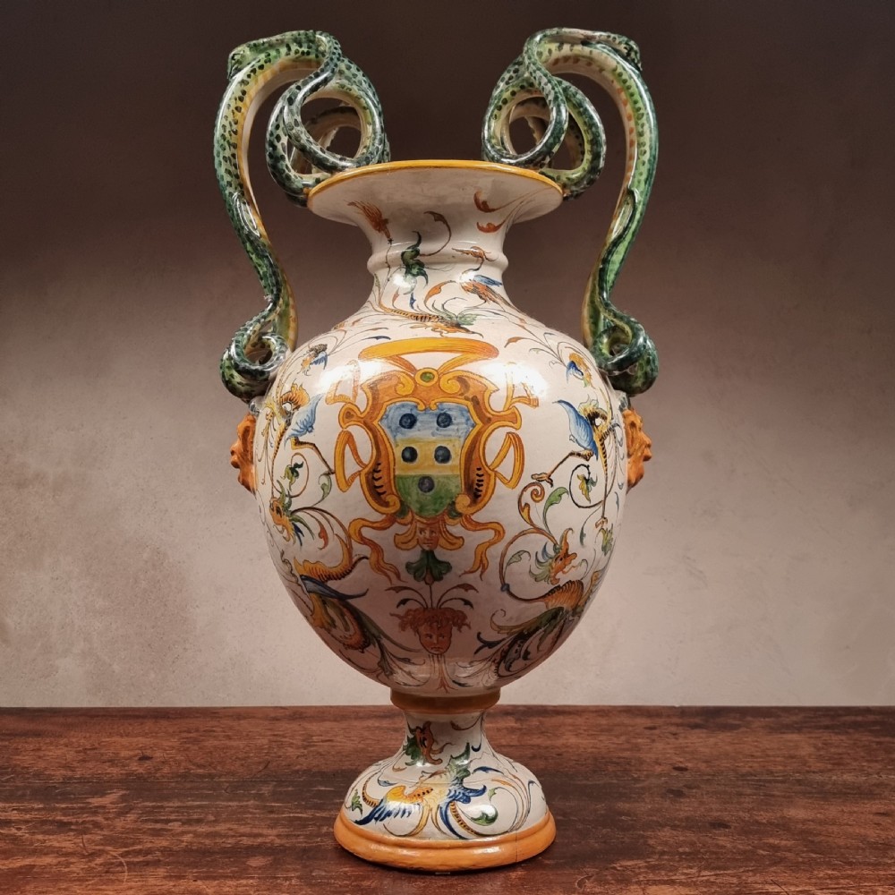 A 19th-century Italian majolica urn vase featuring hand-painted mythological grotesques, a coat of arms, and twin green serpent-formed handles. View VII
