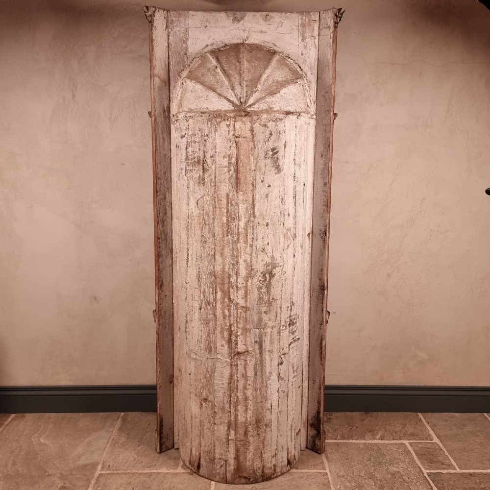 A tall dark mahogany corner cupboard featuring an open carved arched alcove with shaped shelves above a two-door lower cupboard. View VII